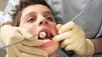 Close-up of boy having teeth examined