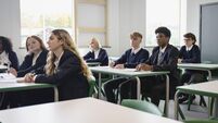 Male and female teenagers in secondary classroom