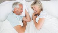 Loving mature couple lying in bed