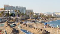 Hammocks and umbrellas lined up on the beach of La Carihuela in Torremolinos. Paradise beach to enjoy your summer holidays. Beac