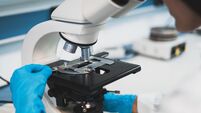 Person working with microscope in lab