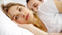 Couple Lying On Bed At Home