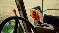 Close-up of a woman hand operating modern combine harvester on farm
