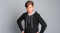Portrait of sad offended teen boy having offended facial expression, isolated on gray background, wearing in casual clothes