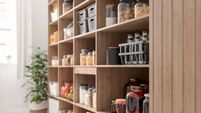 Close-up View Of Organised Pantry Items With Variety of Nonperishable Food Staples And Preserved Foods in Jars On Kitchen Shelf