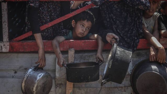 <p>Crowds form as Palestinians, including children, line up in Gaza City, Gaza to receive food distributed by a charity amid ongoing Israeli blockade and attacks on Gaza on July 22, 2025. (Photo by Ali Jadallah/Anadolu via Getty Images)</p>
