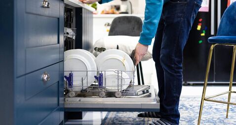 Open Dishwasher Filled With Dirty Plates