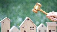 Property auction, Woman hand holding gavel wooden and model house on natural green background, lawyer of home real estate and ow