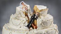 Bride and groom figurines collapsed at ruined wedding cake