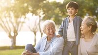 asian grandparent and grandson having fun outdoors in park